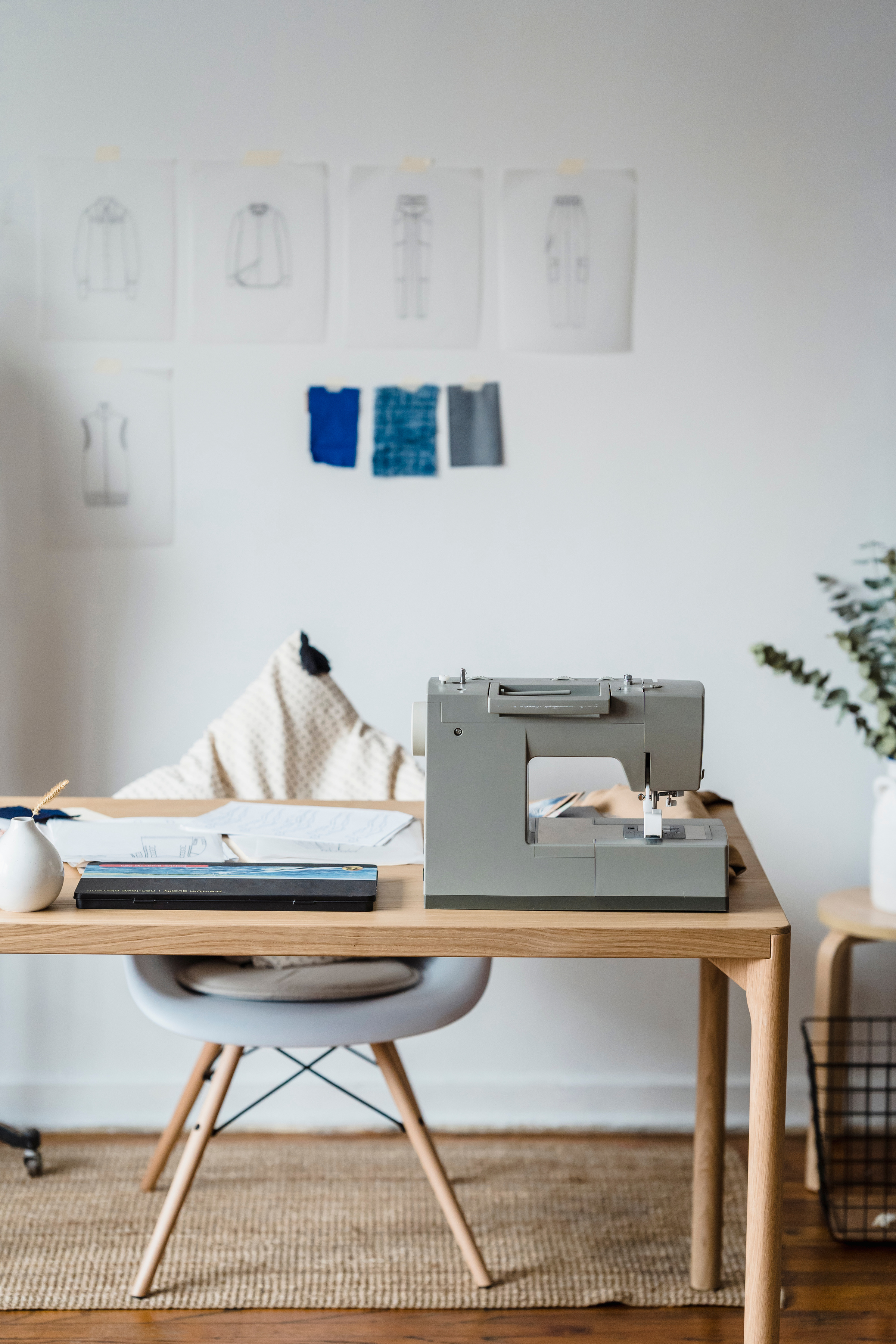 Sewing machine near wall with sketches