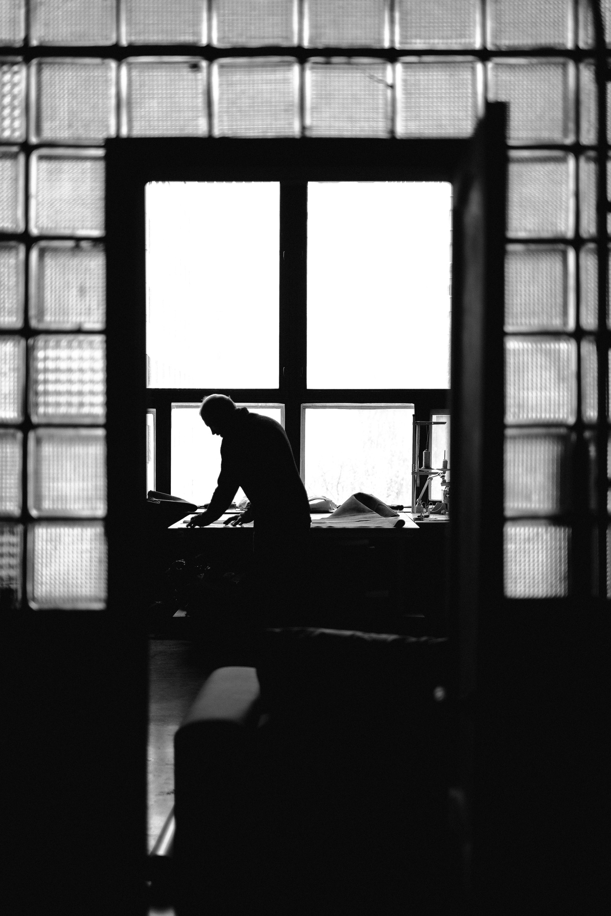 Unrecognizable male tailor working in atelier